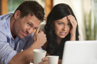 Worried Couple looking at laptop computer